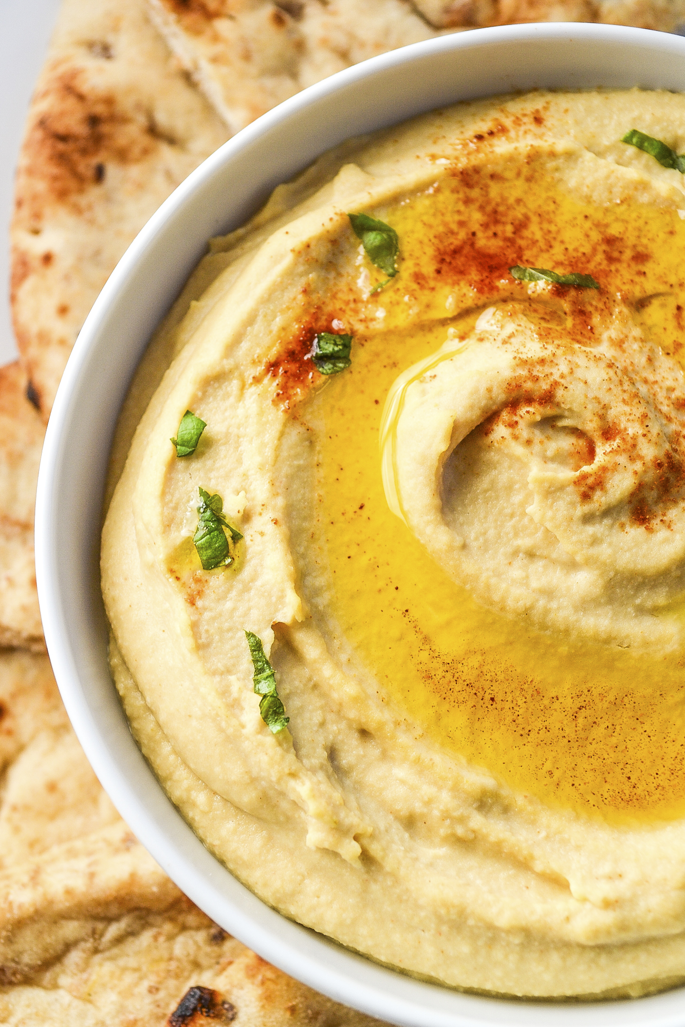 My best easy hummus recipe is smooth, creamy, and delicious! This easy homemade hummus is ready in 5 minutes and better than store-bought! SumofYum.com Hummus made with canned chickpeas and sunflower tahini