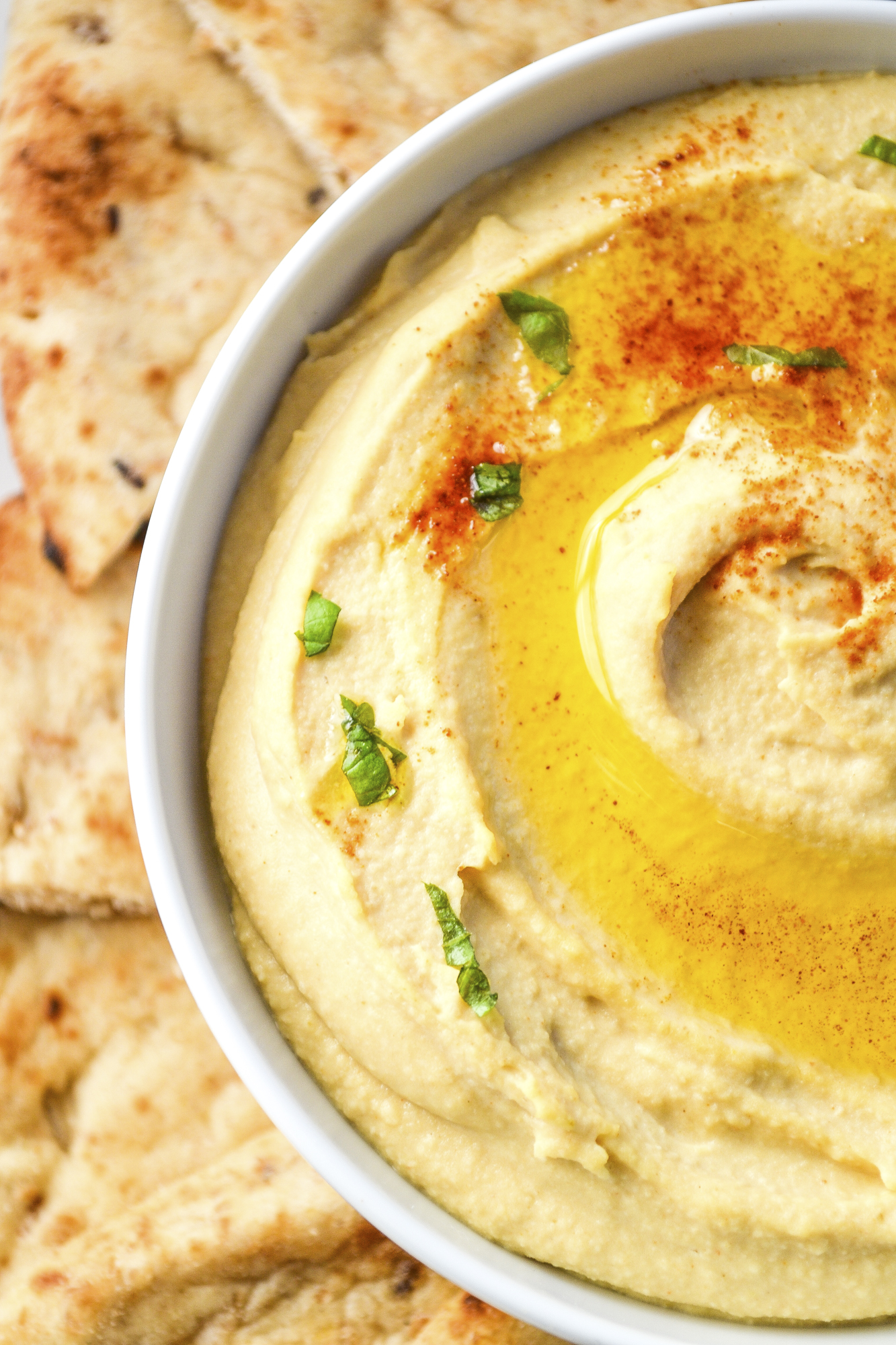 My best easy hummus recipe is smooth, creamy, and delicious! This easy homemade hummus is ready in 5 minutes and better than store-bought! SumofYum.com The Best Hummus made in a blender with canned chickpeas
