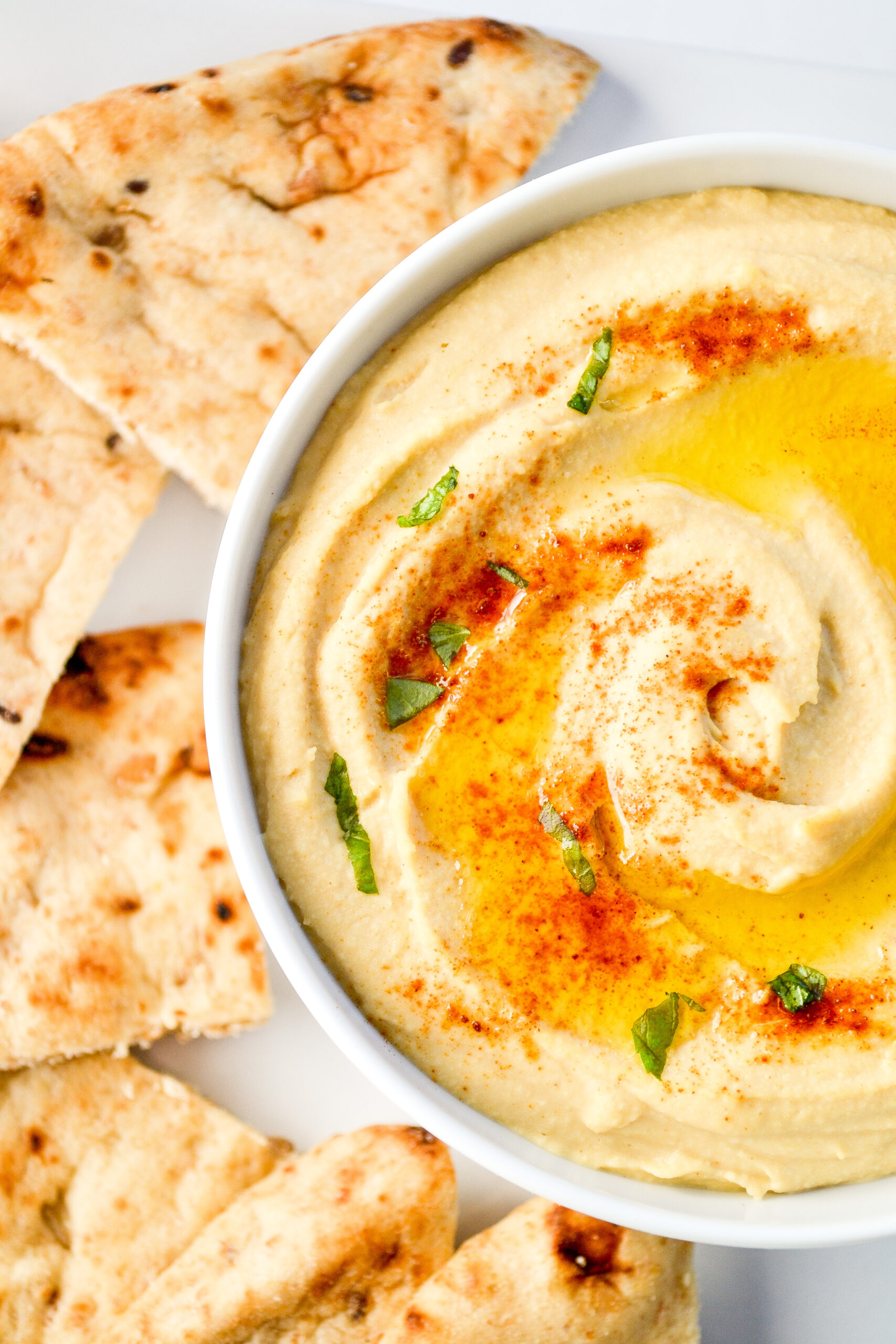 My best and easiest hummus recipe is smooth, creamy, and delicious! This easy homemade hummus is ready in 5 minutes and better than store-bought! SumofYum.com Creamy Hummus made with canned chickpeas