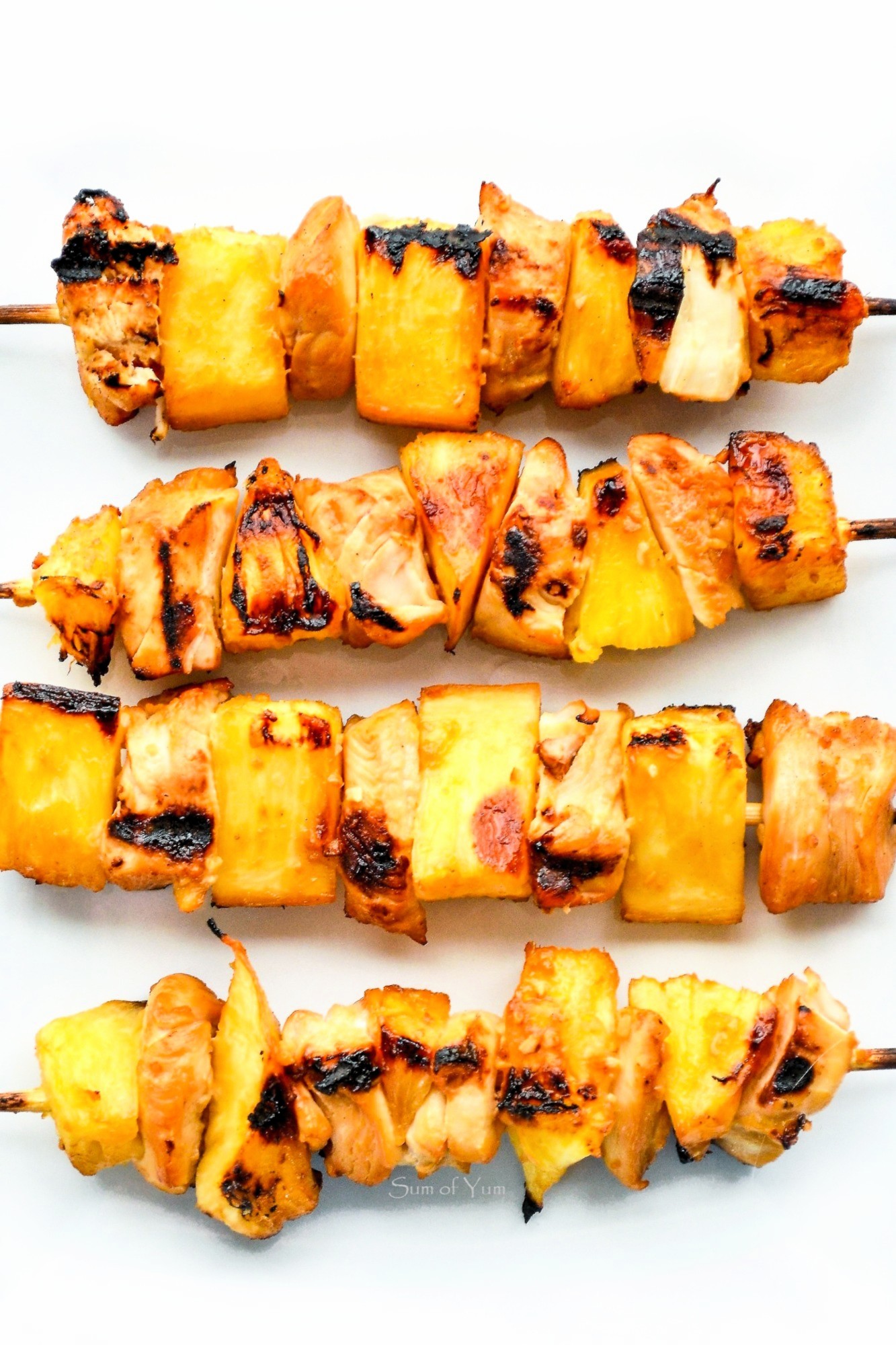 Grilled Hawaiian Pineapple Chicken Kabobs are tender, juicy, flavorful, healthy and delicious! These skewers are perfect for a summer luau! Recipe on sumofyum.com Hawaiian Chicken Kabobs