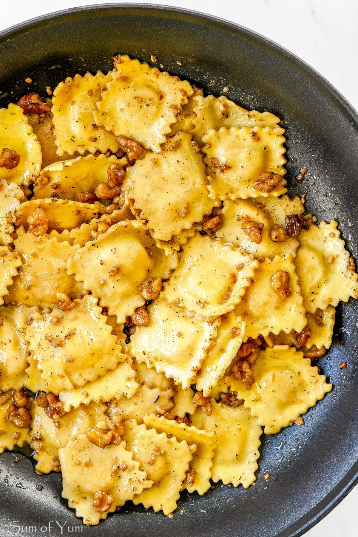 Ravioli with Sage Butter Sauce and Walnuts in pan