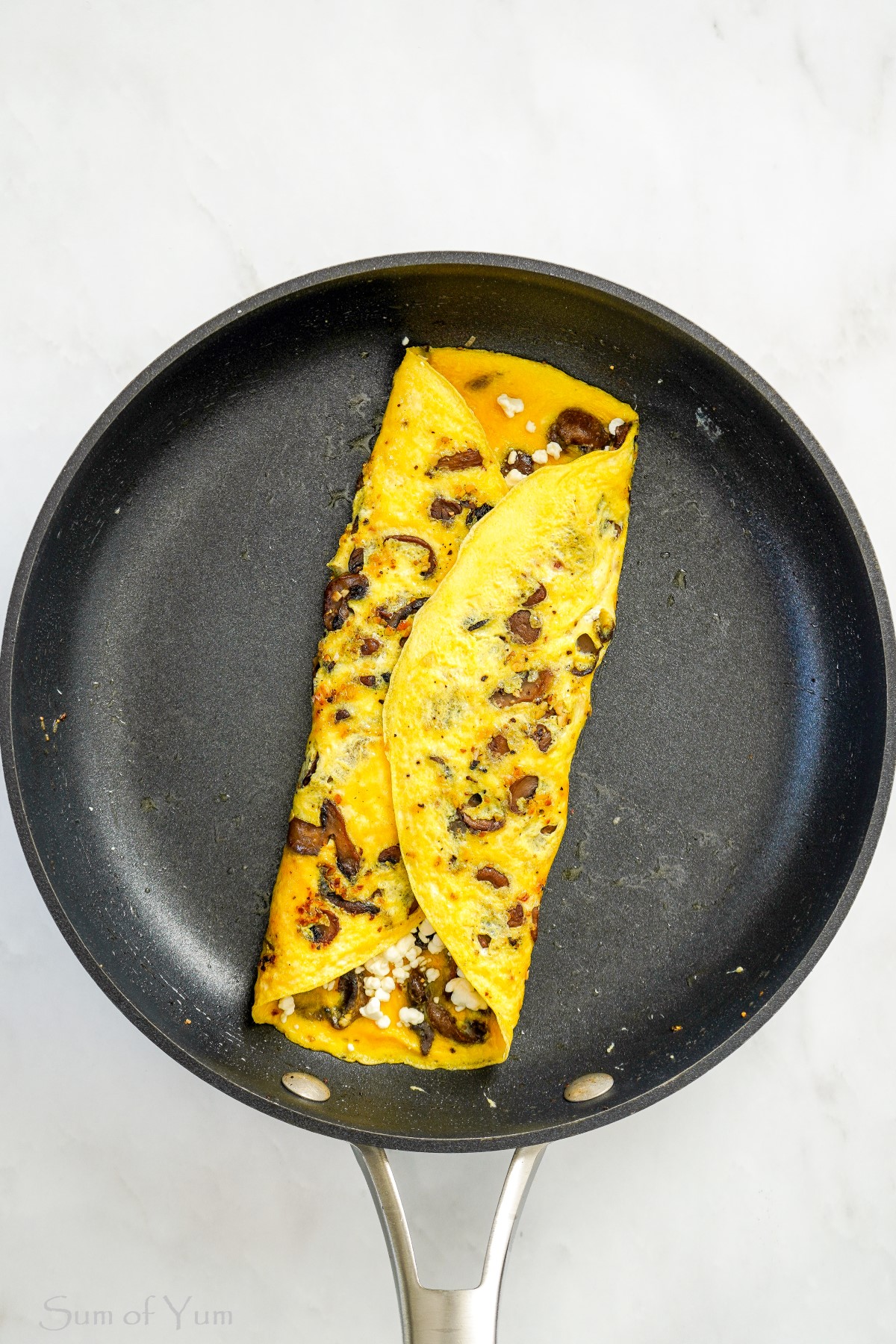 Omelet with mushrooms and cheese in pan
