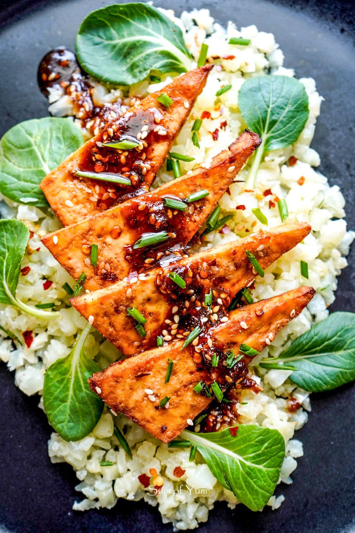 This Maple Glazed Tofu recipe is sweet, savory, spicy, and a flavorful plant-based protein to make a delicious vegan meal served with rice, noodles, veggies, and more! SumofYum.com Baked Maple Glazed Tofu