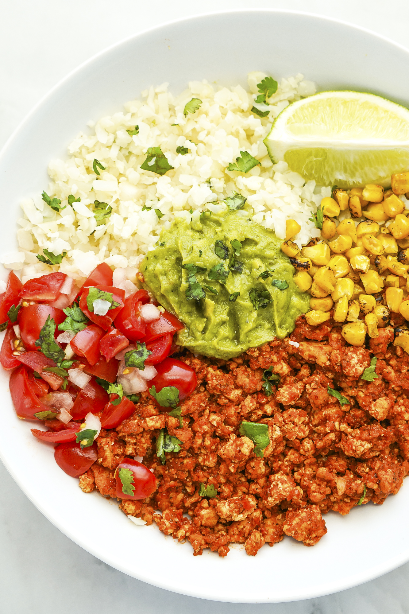 This easy burrito bowl recipe has lots of filling, topping, and protein choices, with vegetarian options, for cauliflower rice burrito bowls. SumofYum.com Vegetarian Cauliflower Rice Burrito Bowl