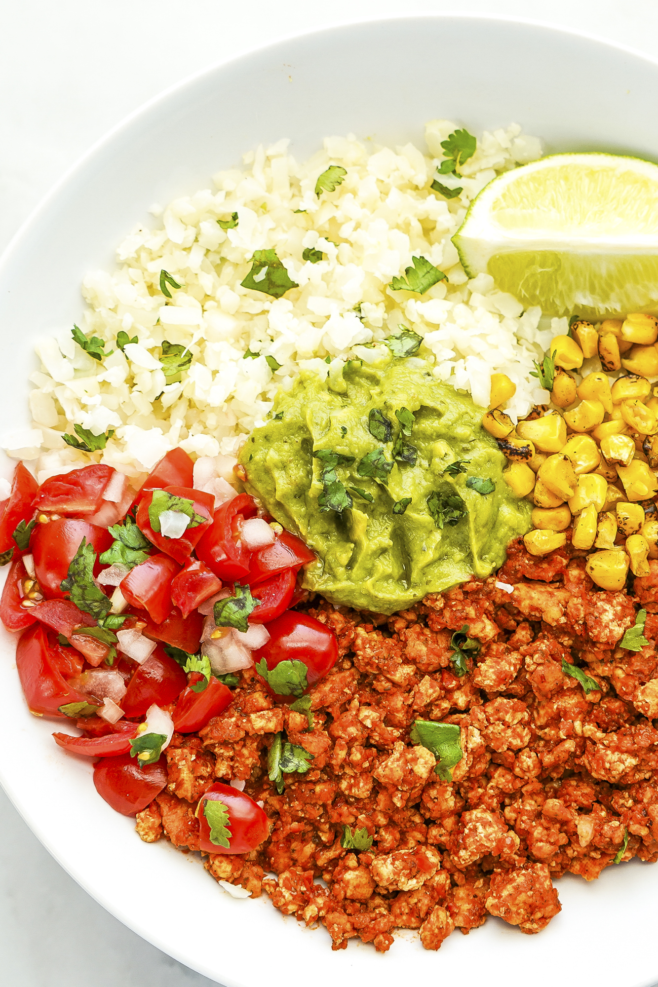 This easy burrito bowl recipe has lots of filling, topping, and protein choices, with vegetarian options, for cauliflower rice burrito bowls. SumofYum.com Burrito Bowl
