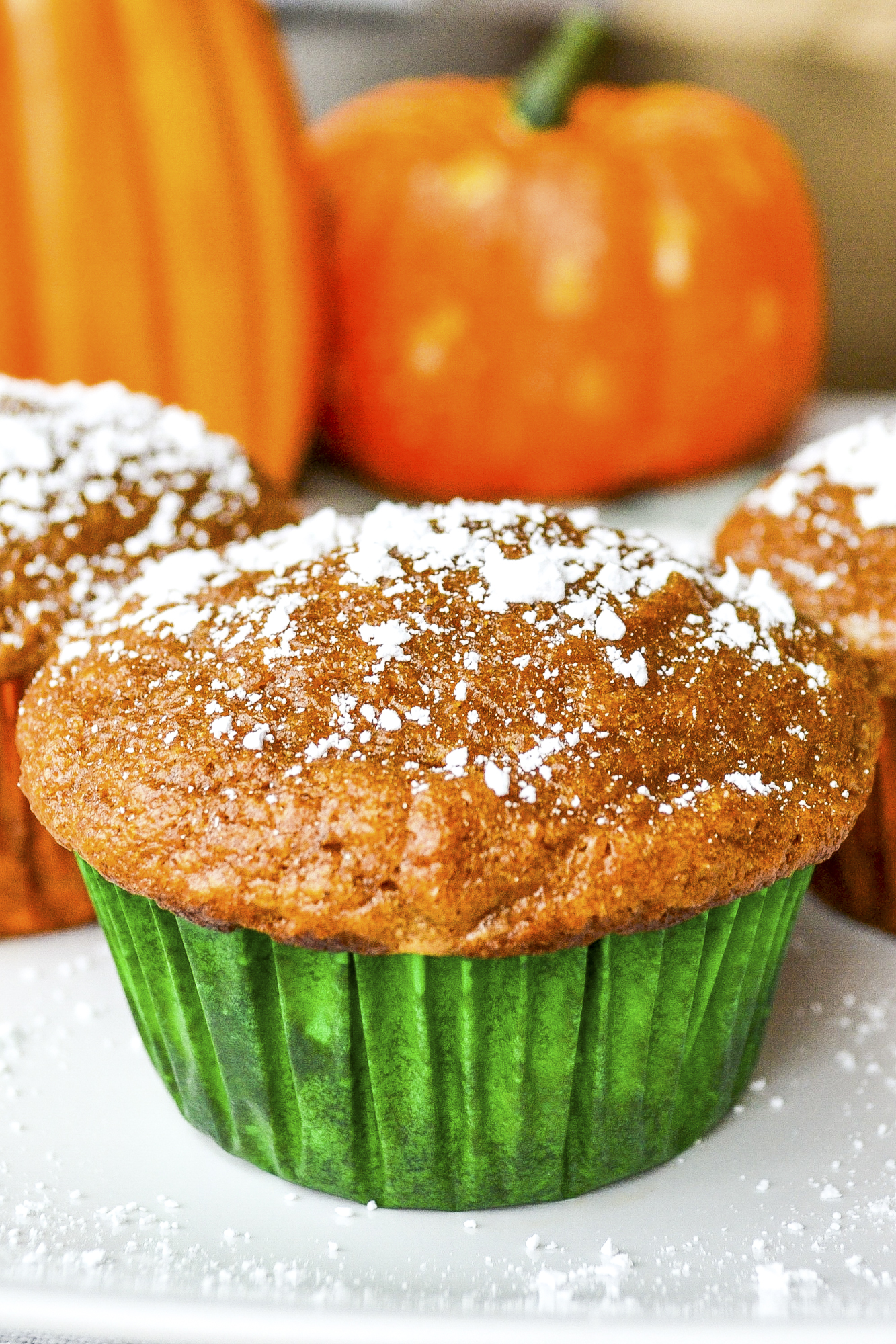 Pumpkin cake muffins made from scratch are moist and delicious. This easy pumpkin muffin recipe includes pumpkin pecan muffins and more! SumofYum.com Pumpkin Cake Muffins